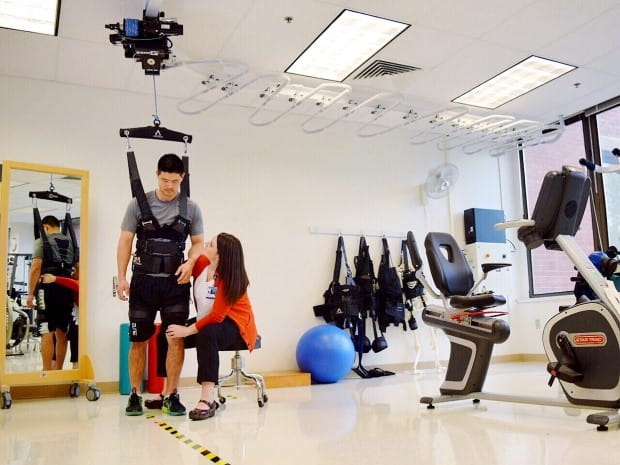 Rehabilitation Institute of Oregon image of an individual in an assisted jumper apparatus that allows the individual to practice walking