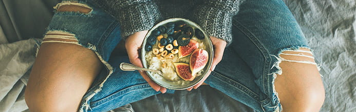 Woman holding bowl of healthy food