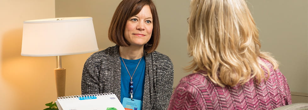 Woman doctor speaking to patient about treatment