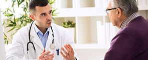Prostate cancer doctor talking with male patient