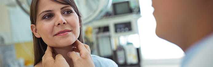 Cancer specialist examining a patient's neck checking for oral, head and neck cancers