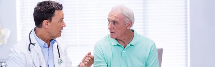 Urologist doctor discusses prostate cancer diagnosis with patient