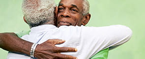 Two men hugging donors