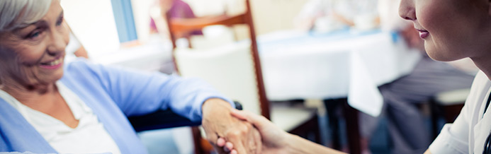 Legacy doctor and patient hold hands for healing