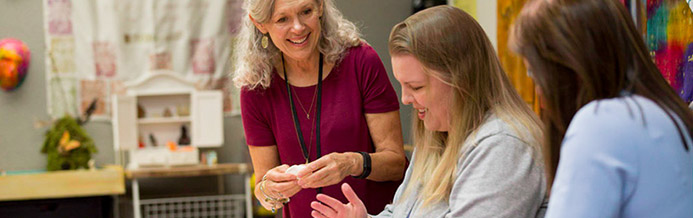 Art therapist and two patients make crafts