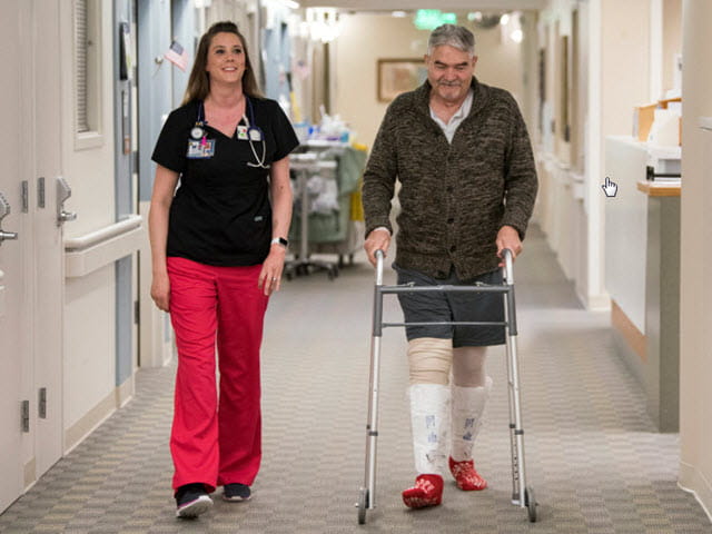 R.N. Christina Gay on a walk with her patient 