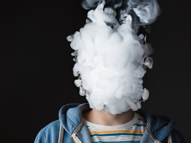 person obscured by vaping cloud