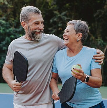 Couple playing pickleball