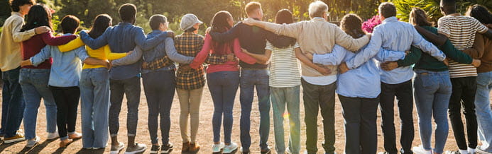 A group of people linking arms and offering support