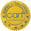circular gold medal icon stating ASPIRE to Excellence, with the acronym carf in the center, with ACCREDITED below it