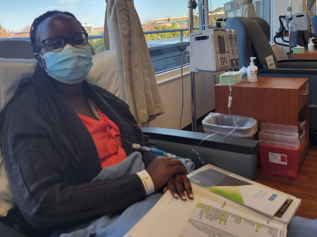 Keziah pictured sitting in recliner with some paperwork
