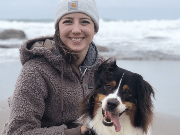 Photo of Sarah Fulkerson at the beach with her dog