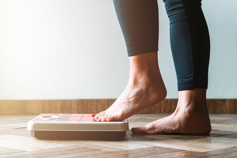 person stepping on scale